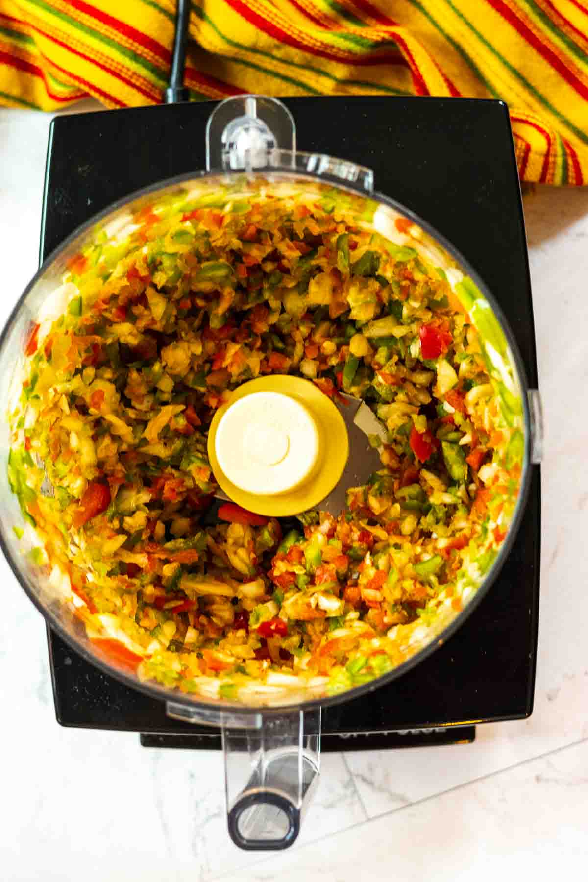 Vegetables chopped in a food processor to make freezer salsa.