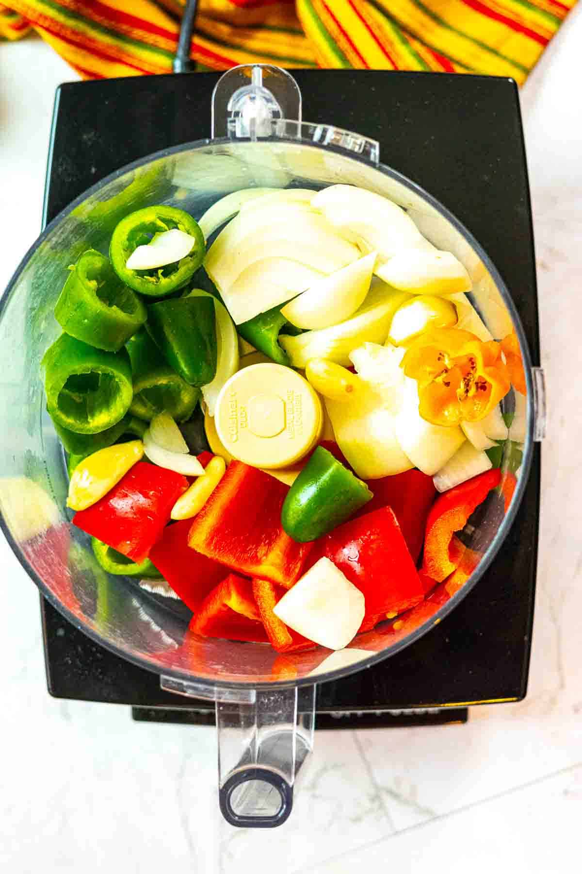 Vegetables in a food processor to make Freezer Salsa.