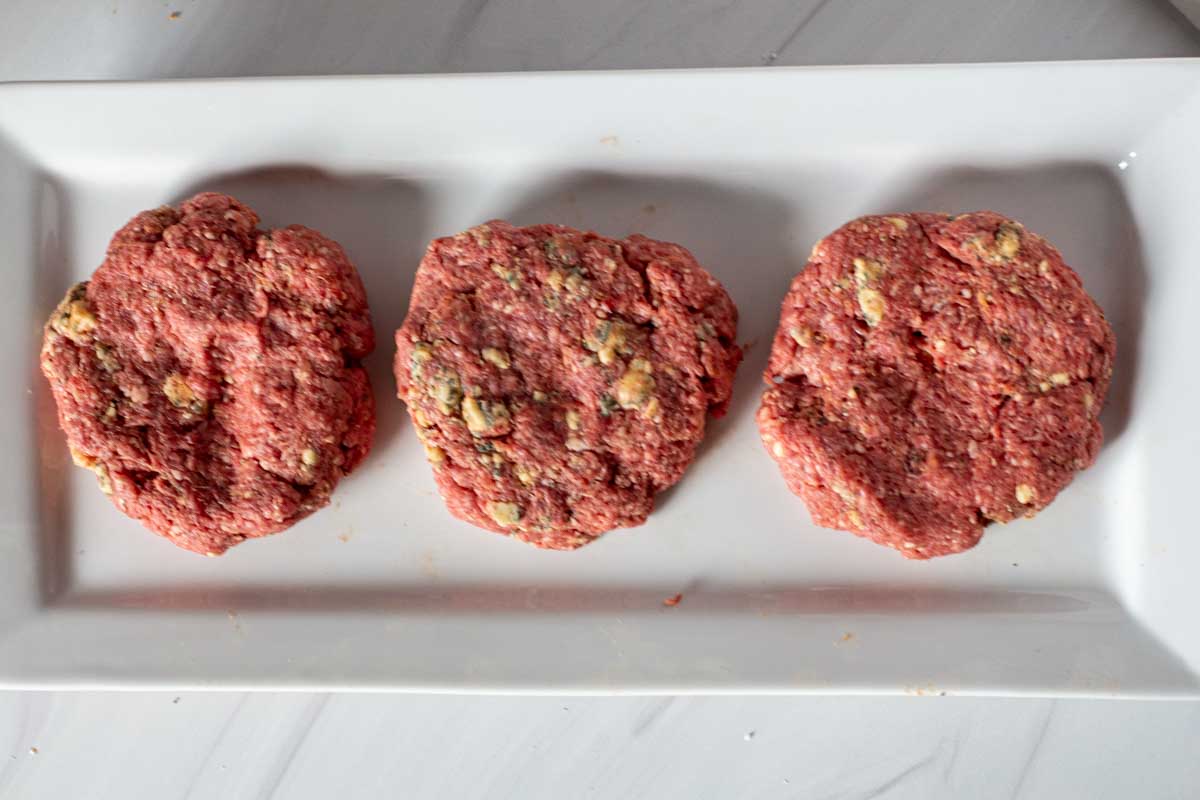 Blue cheese burger patties ready to cook.