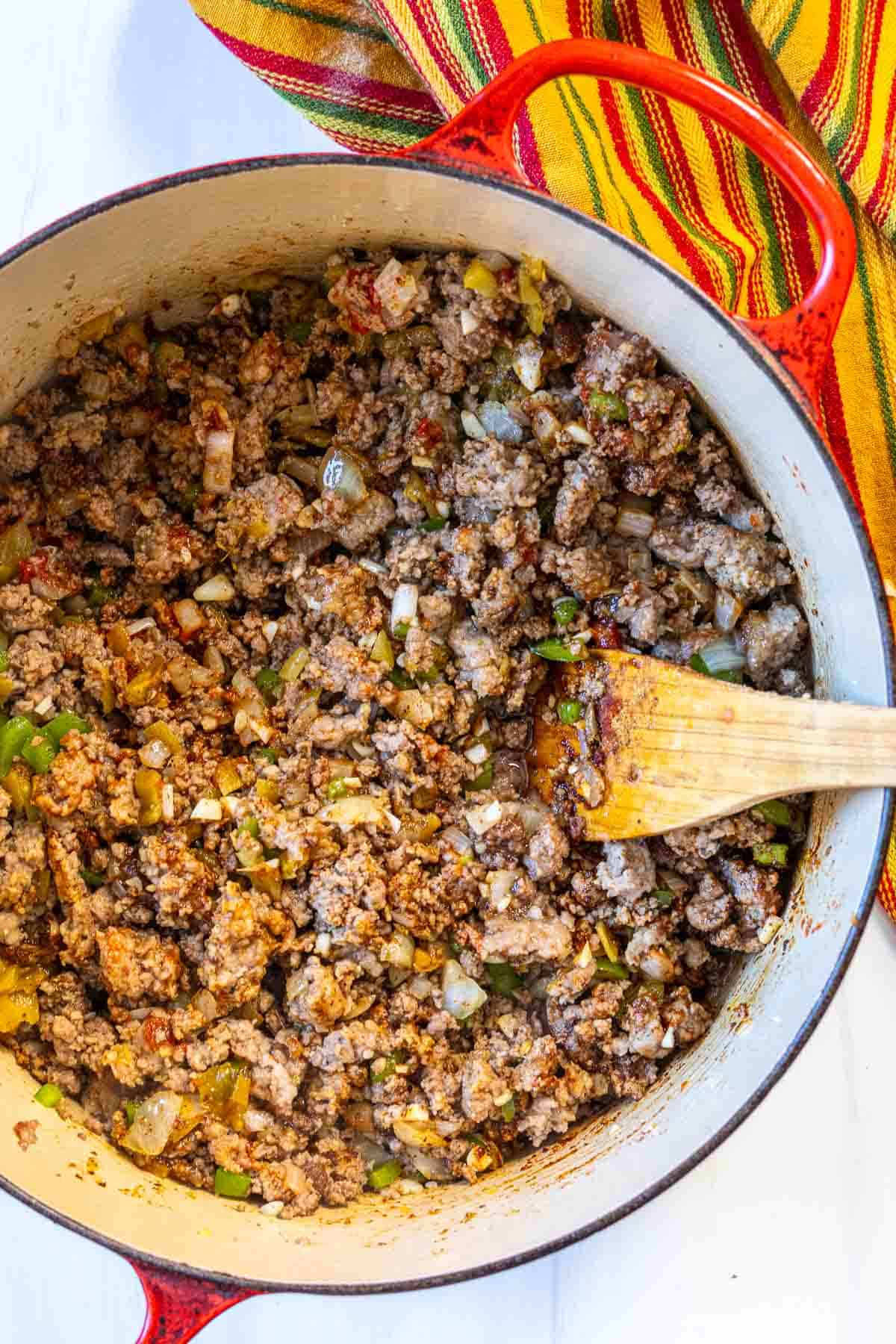 Cooking chili meat in a Dutch oven.