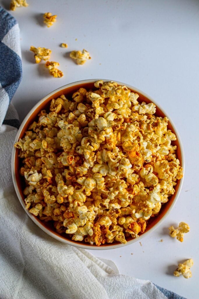 A bowl of homemade popcorn with spicy seasoning for how to cook stovetop popcorn