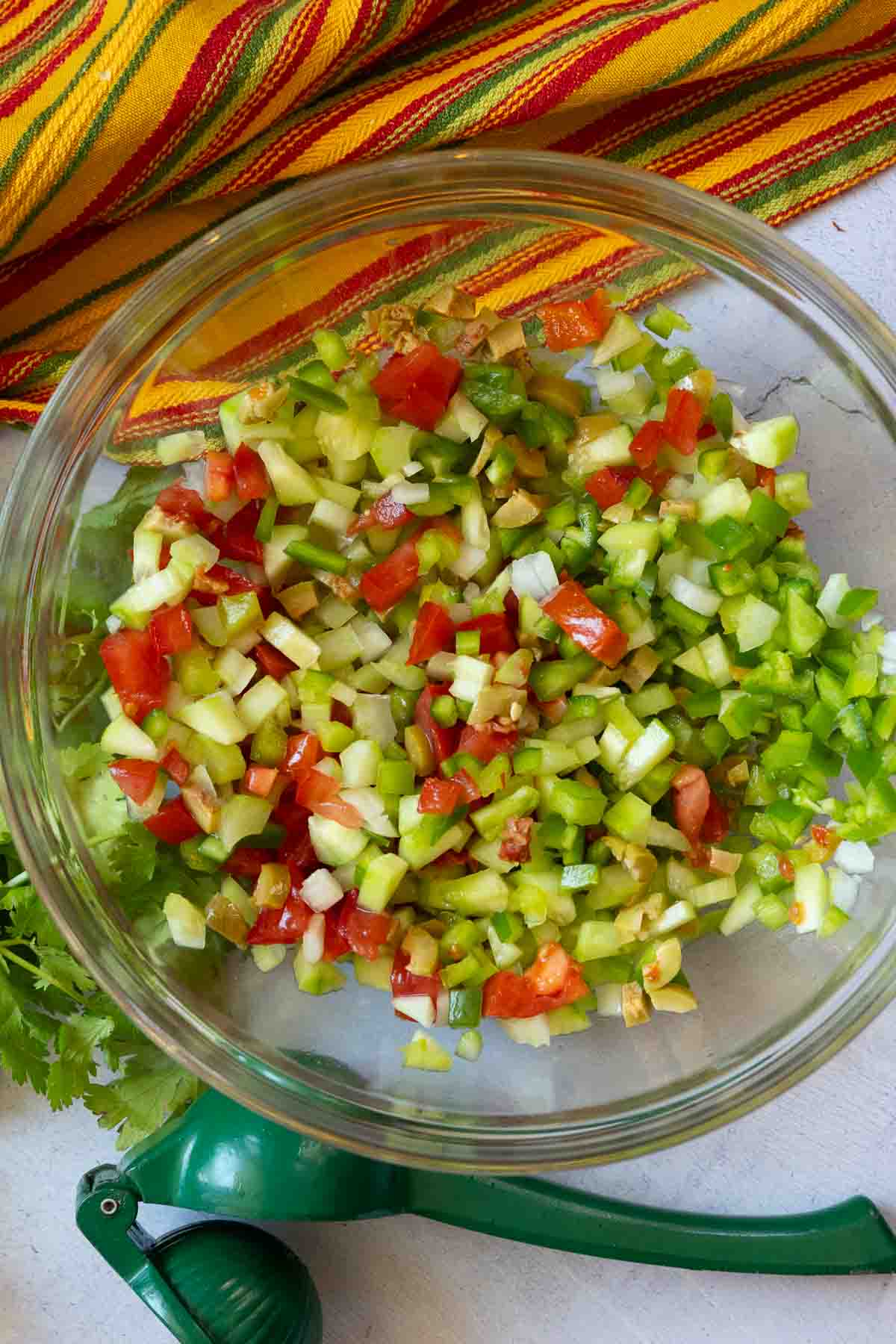 Step 3 to make campechana. Mixing vegetables together.