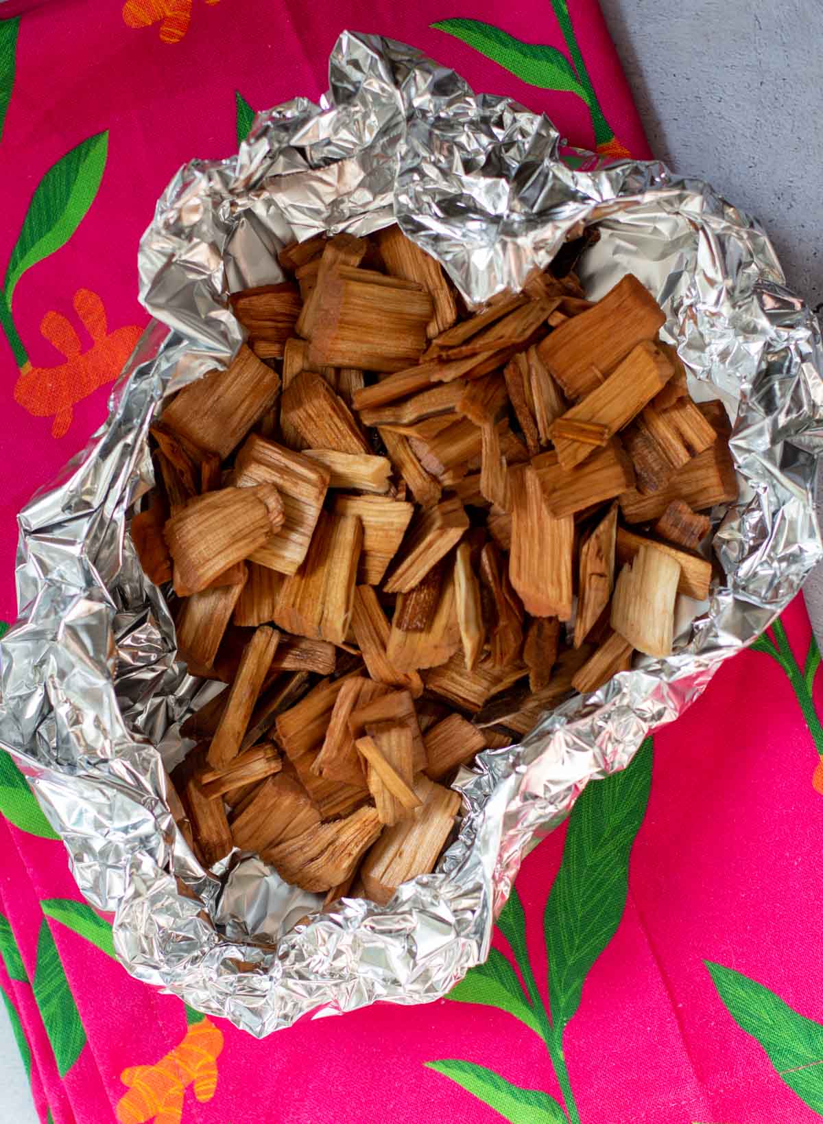 Cherry wood chips in tin foil for grilled chicken.