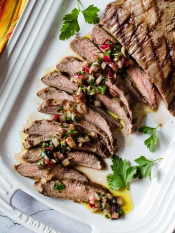 Flank steak topped with chimichurri sauce.