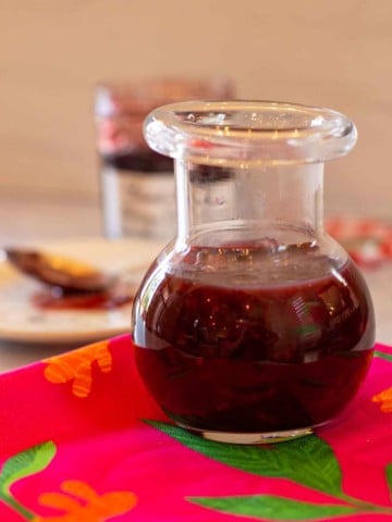 Homemade cherry bbq sauce in a glass bottled.