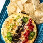 Savory Mexican Cheesecake Appetizer on a blue Le Creuset platter.