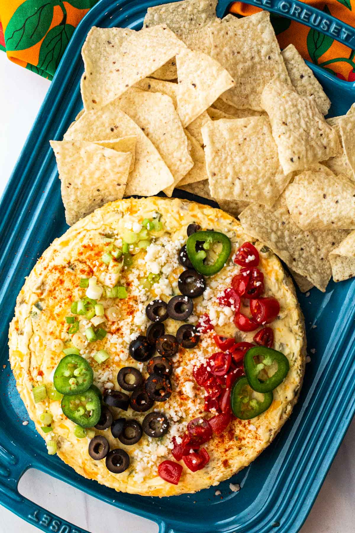 Savory Mexican Cheesecake Appetizer on a blue Le Creuset platter.