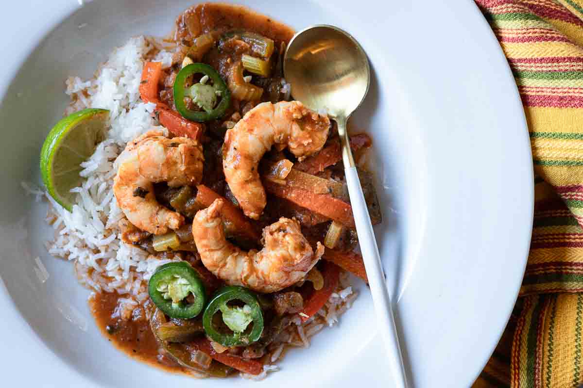 Shrimp Stew in a white bowl served over rice.