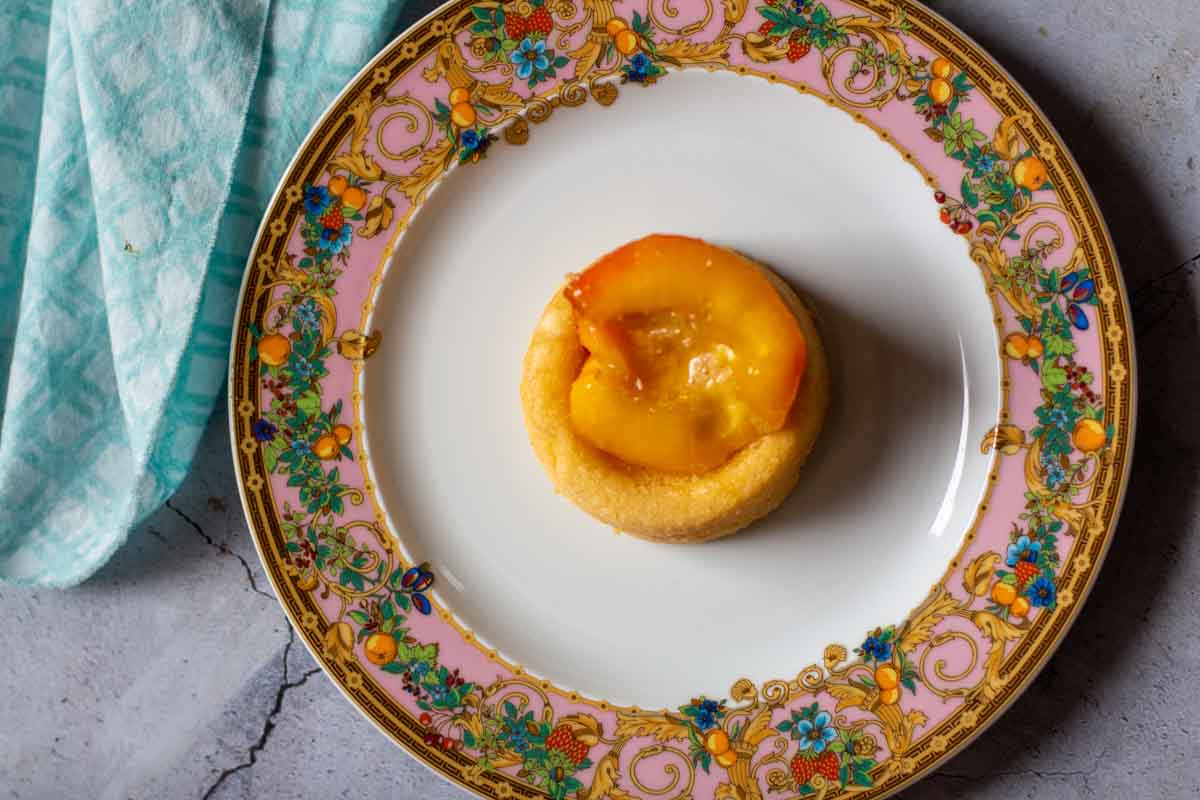 Roasted peach half on a vanilla dessert shell.