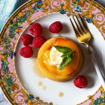 Vanilla roasted peaches with mascarpone, raspberries on a Versace plate.