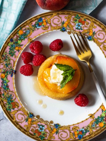 Vanilla roasted peaches with mascarpone, raspberries on a Versace plate.