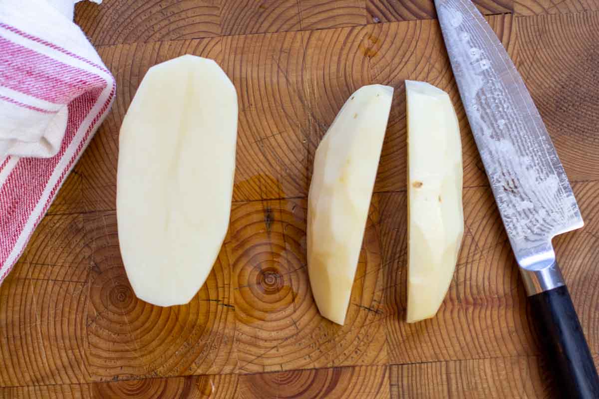 How to cut a potato into wedges to make home fries.
