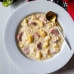 Creamy sauerkraut soup with sausage and potatoes.