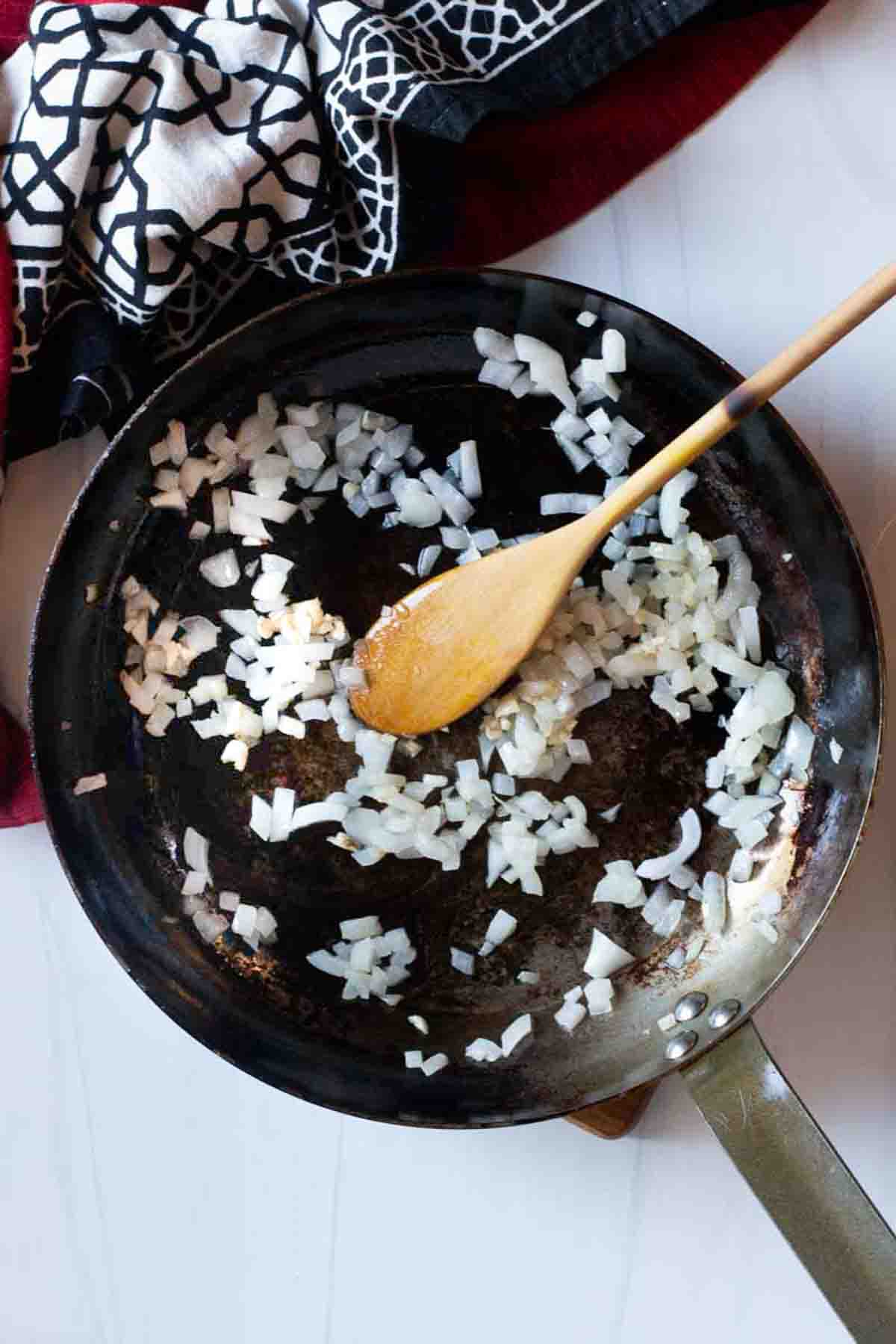 Cooking onions to make sauerkraut soup.