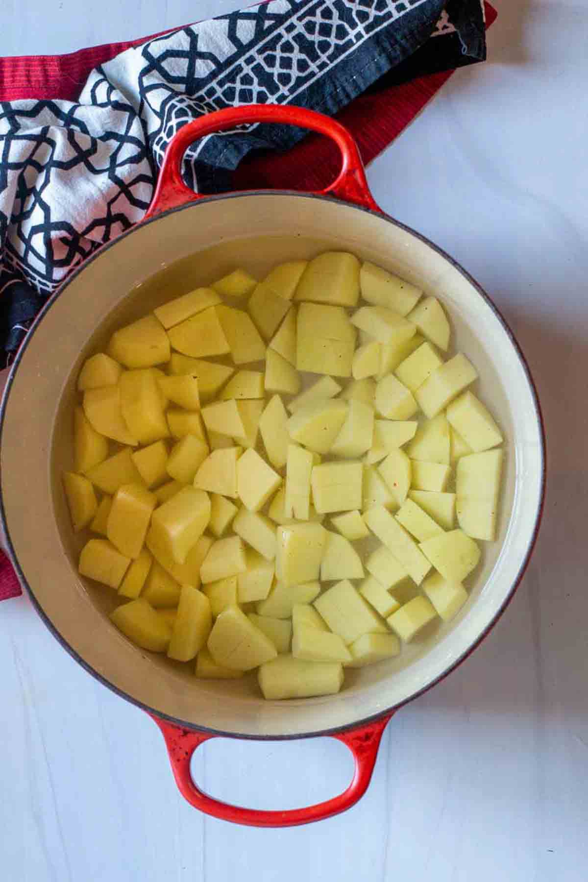 Boiling potatoes to make sauerkraut soup.