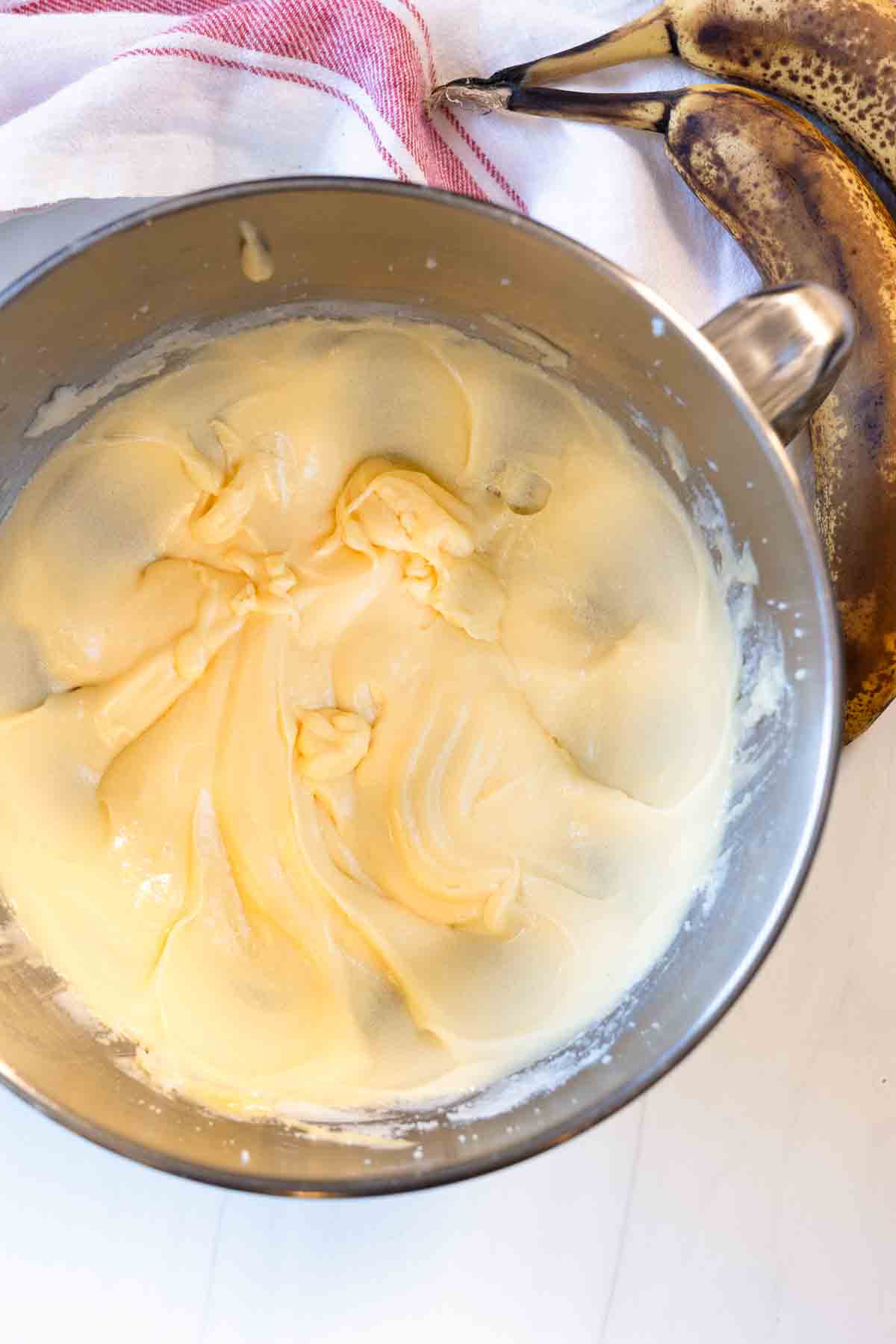 Creaming shortening and sugar to make old fashioned banana nut bread.
