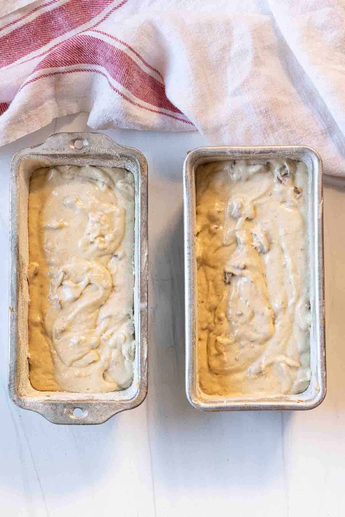 Adding banana nut bread batter to loaf pans.