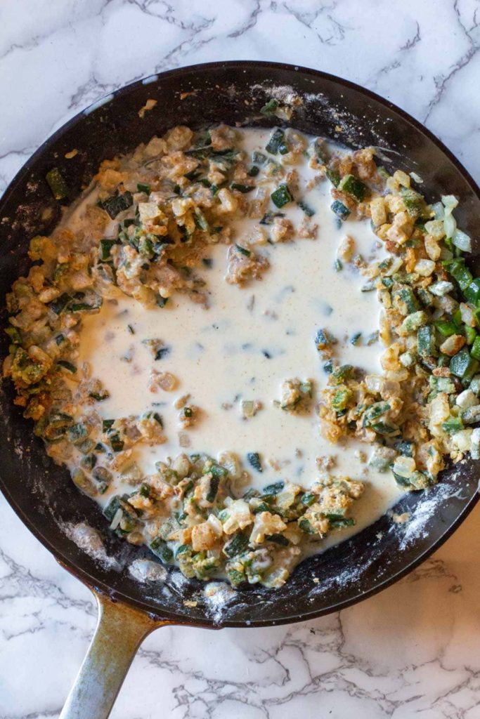 Adding milk to vegetable mixture for chicken cheese soup