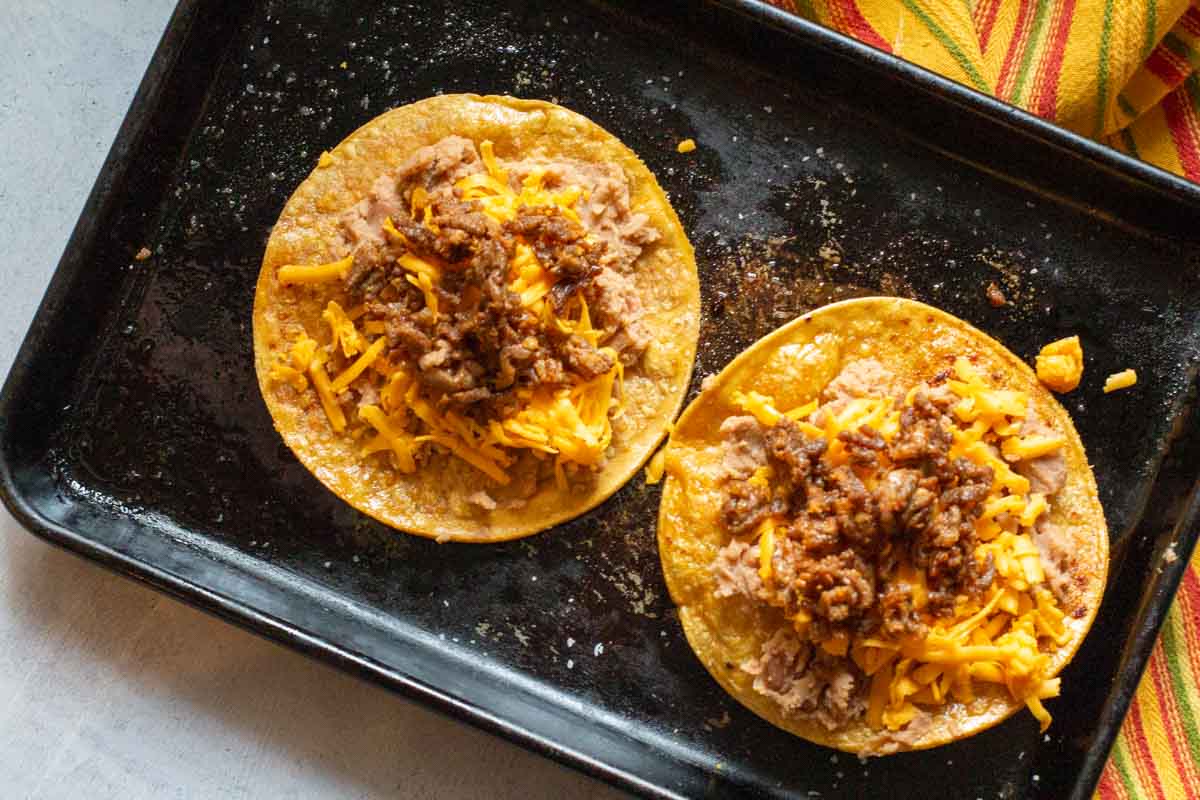 How to make a tostada with refried beans, cheese and chorizo.