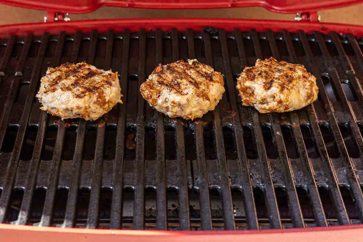 Chicken burgers on the grill.