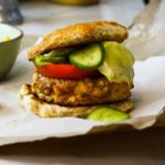Chicken chorizo burger topped with tomato lettuce and pickles.