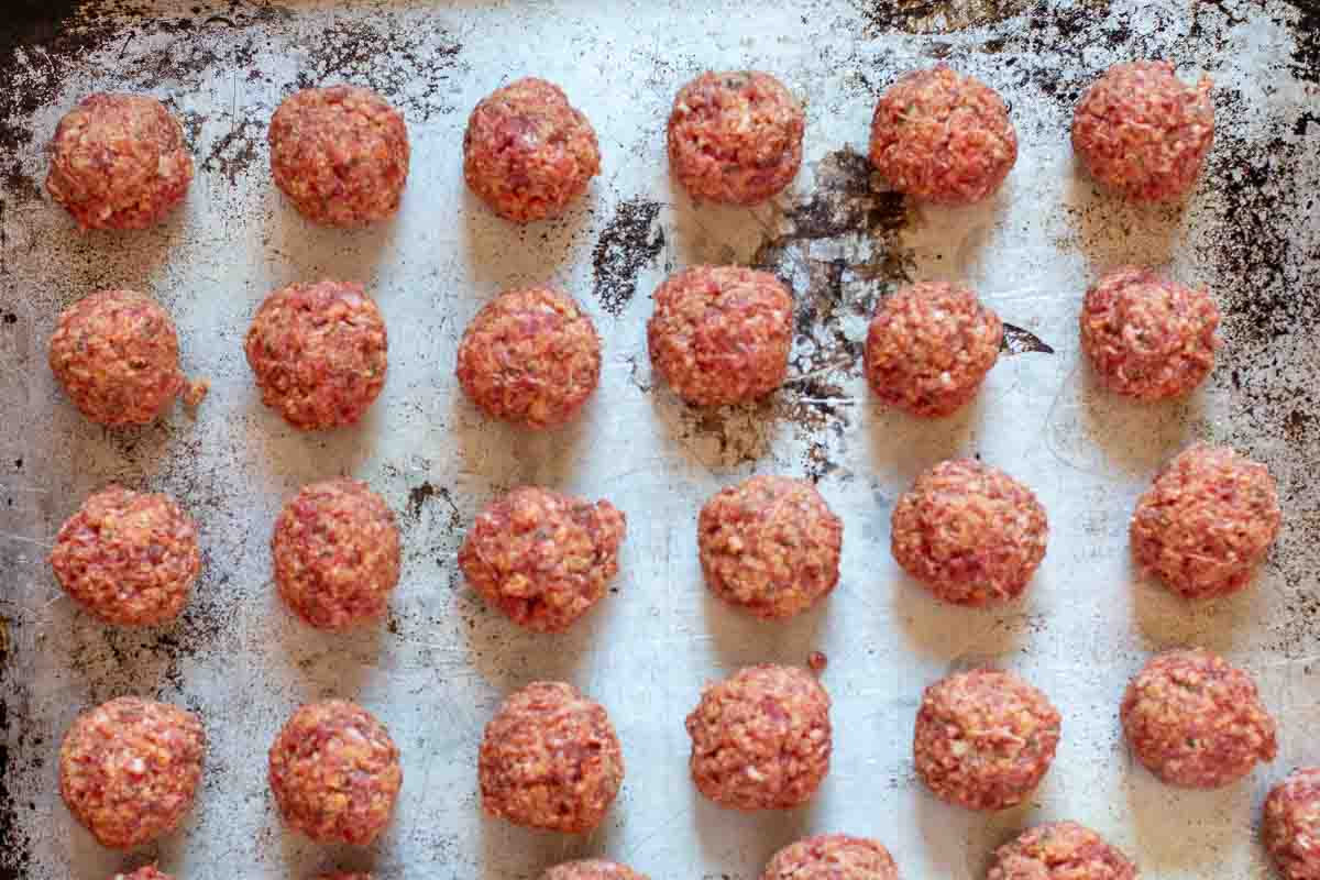 Spicy lamb meatballs on a sheet pan ready to bake.