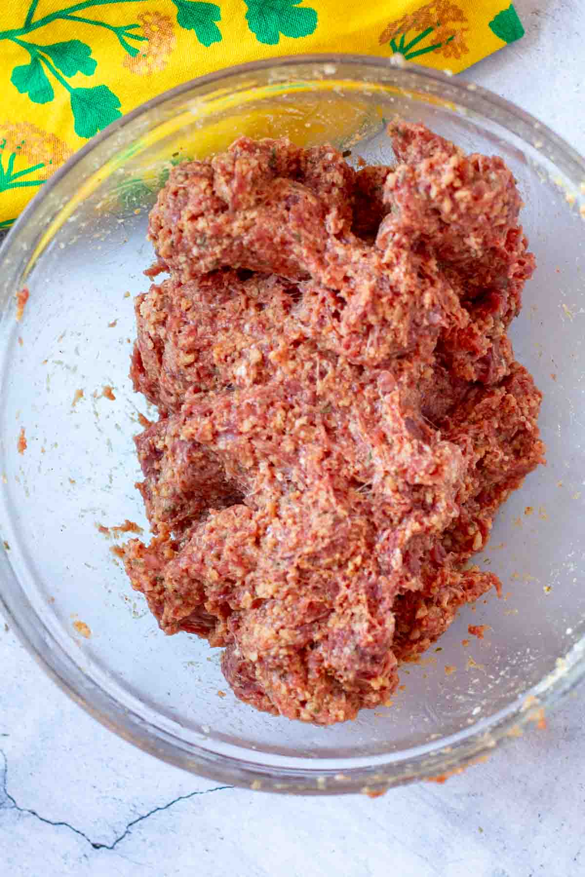 Mixture of ground lamb and ingredients to make spicy lamb meatballs.