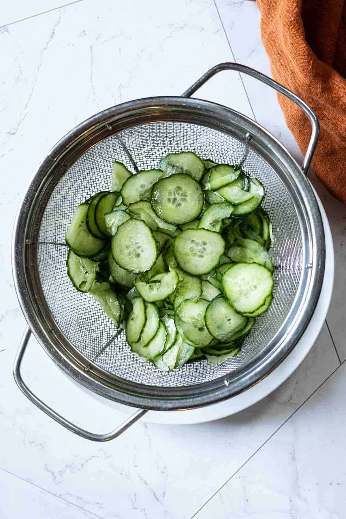 Letting cucumbers drain before adding to a pickling solution.