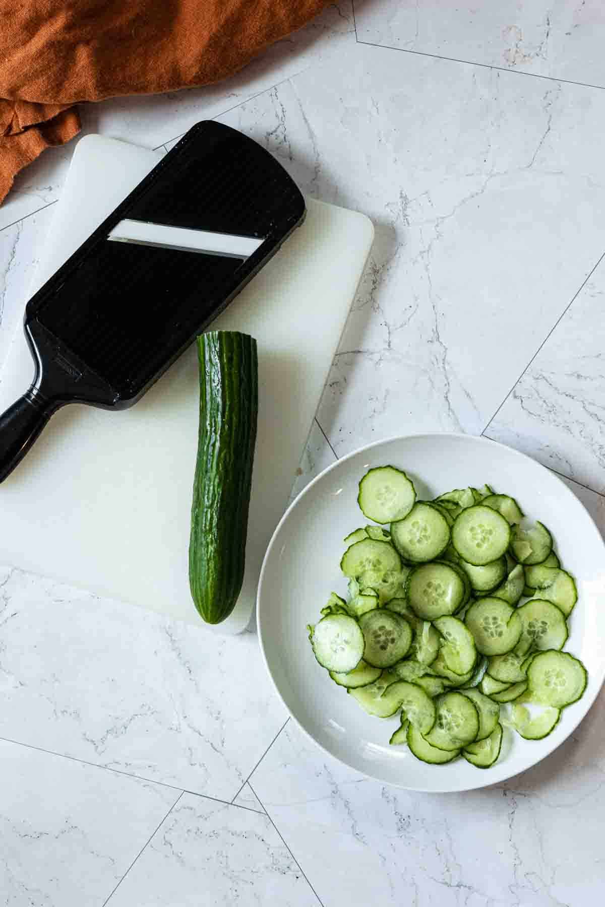 Slicing English Cucumbers with a mandolin.