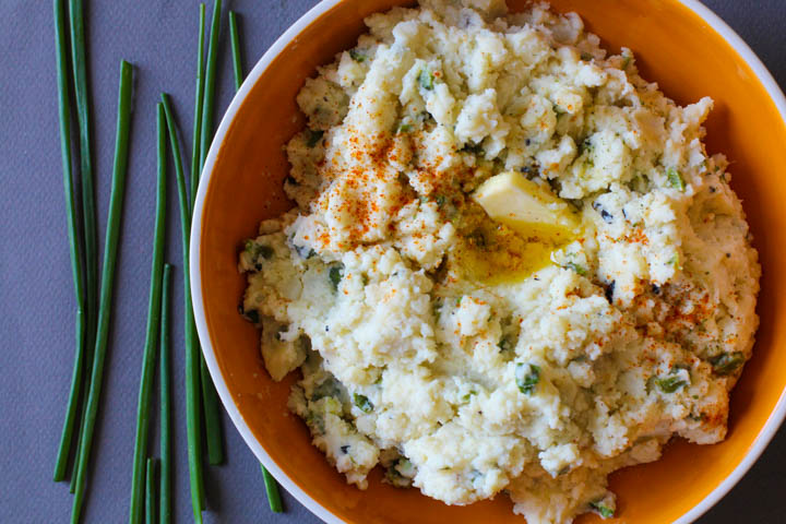 Orange bowl with mashed potatoes with poblanos and chives.
