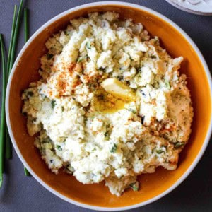 A bowl of poblano mashed potatoes with chives.
