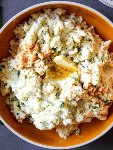 A bowl of poblano mashed potatoes with chives.