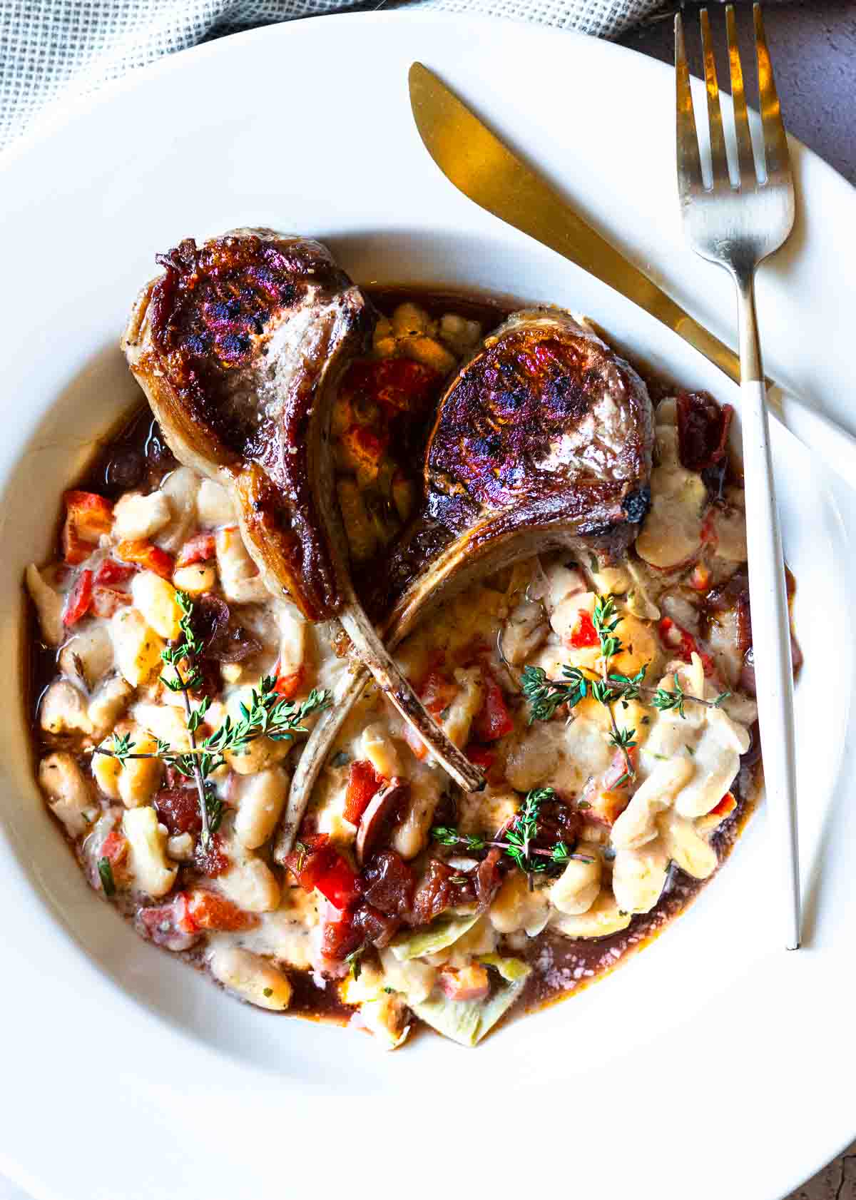 Lamb lollipops served over white beans drizzled with red wine reduction sauce.