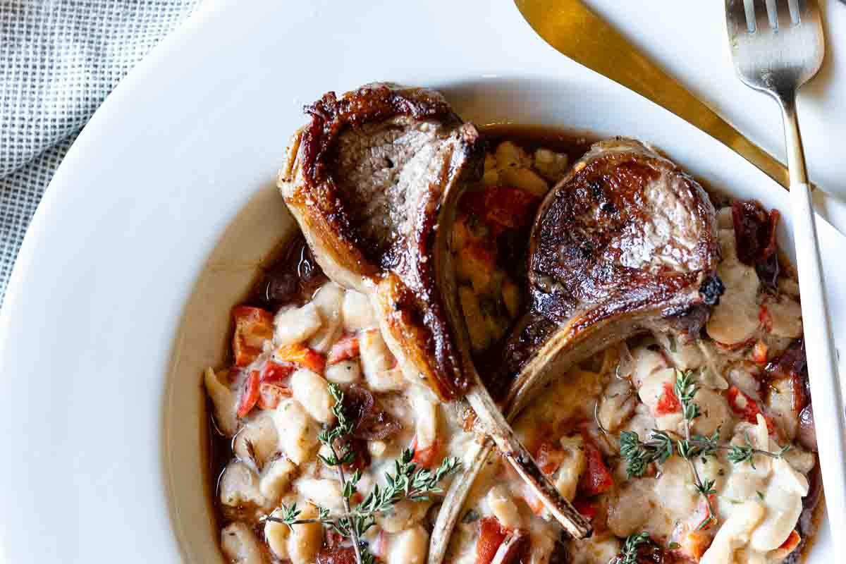 Lamb lollipop chops served over white beans.