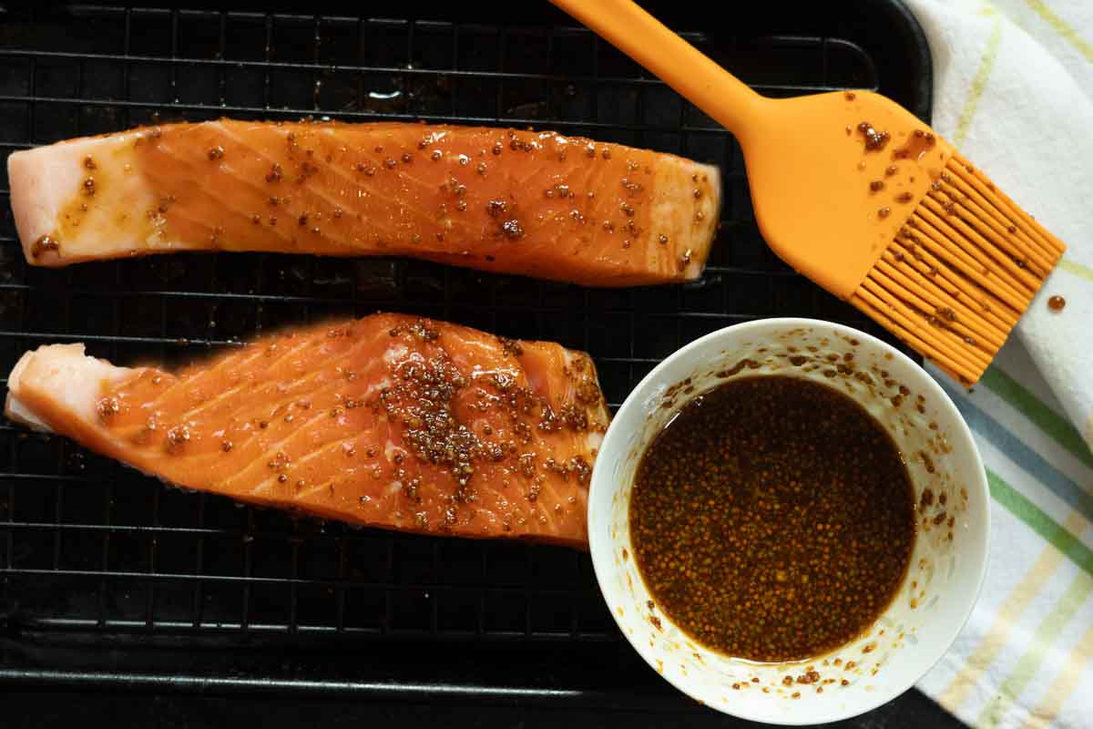 Basting maple syrup salmon.