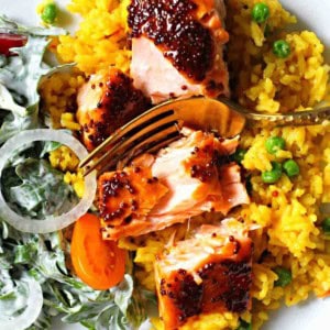 Glazed Maple Syrup Salmon served over yellow rice.