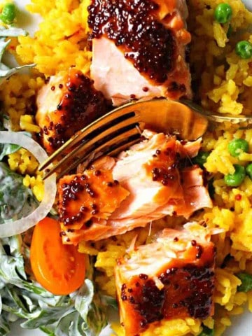 Glazed Maple Syrup Salmon served over yellow rice.