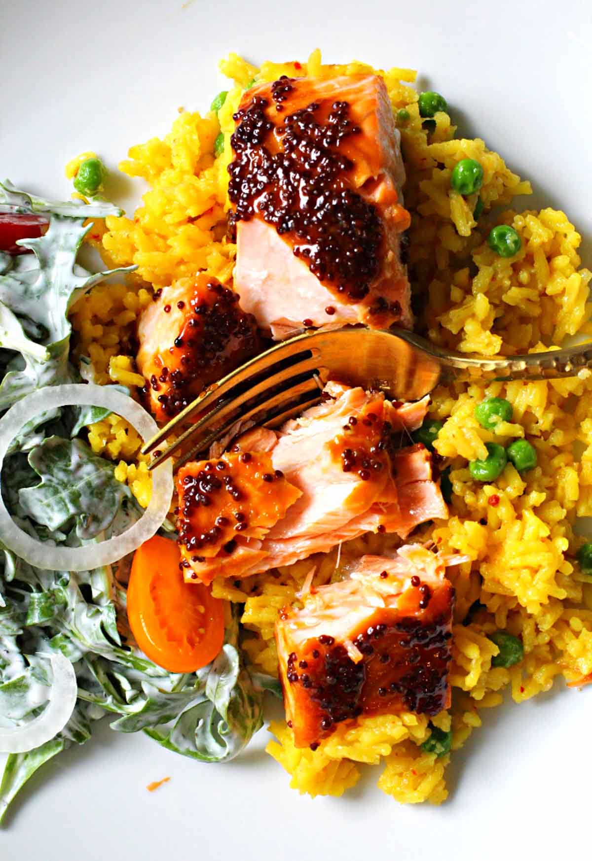 Salmon fillets glazed with maple mustard served over yellow rice and a side salad tossed with buttermilk ranch dressing
