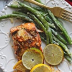 Lemon lime salmon with slices of lemons and limes served with french green beans.