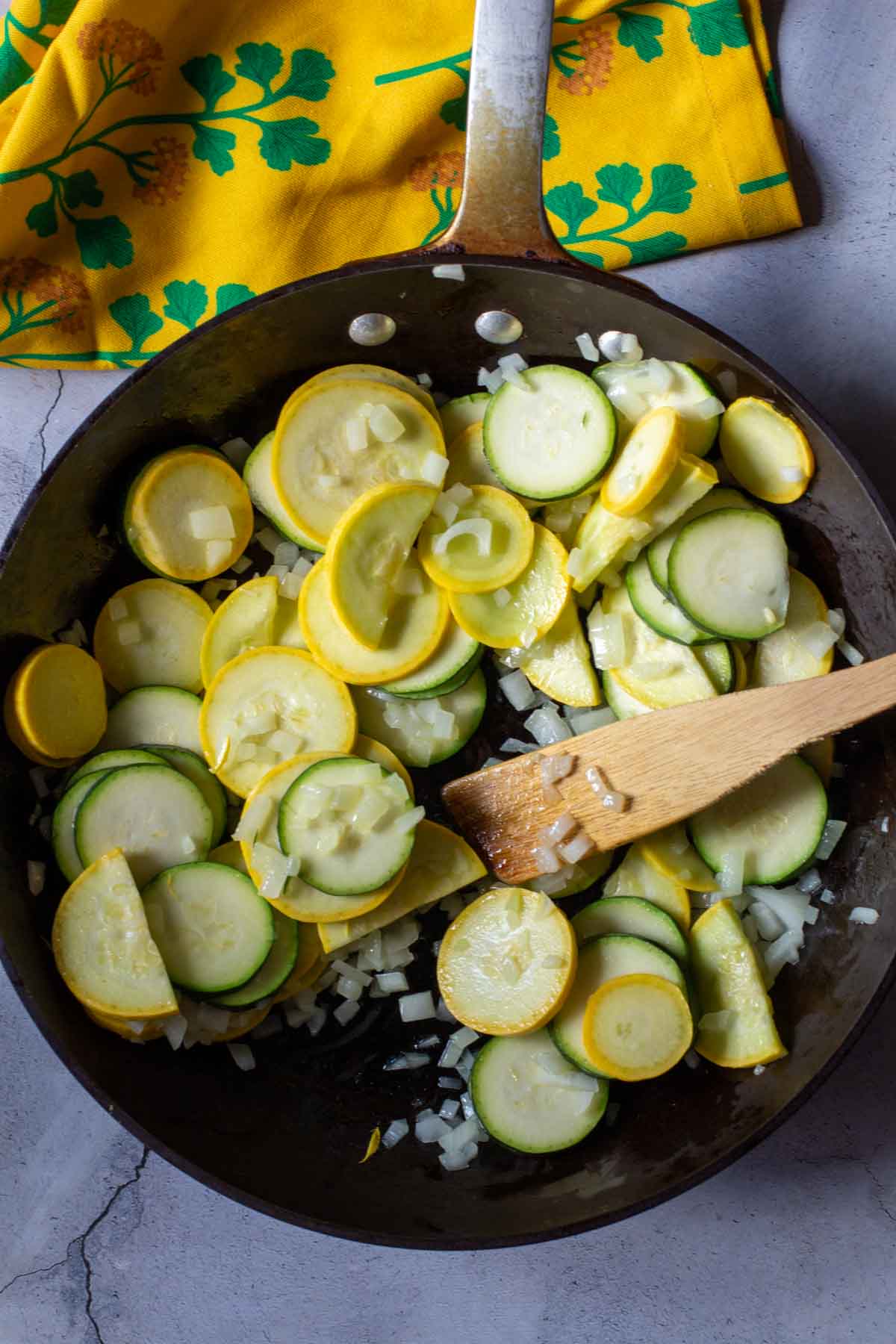 Cooking summer squash and zucchini in a non-stick skillet.