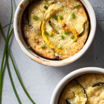 Zucchini squash casserole baked in individual ramekins.