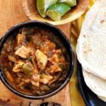 Hatch Green Chili With Pork served with flour tortillas and lime wedges
