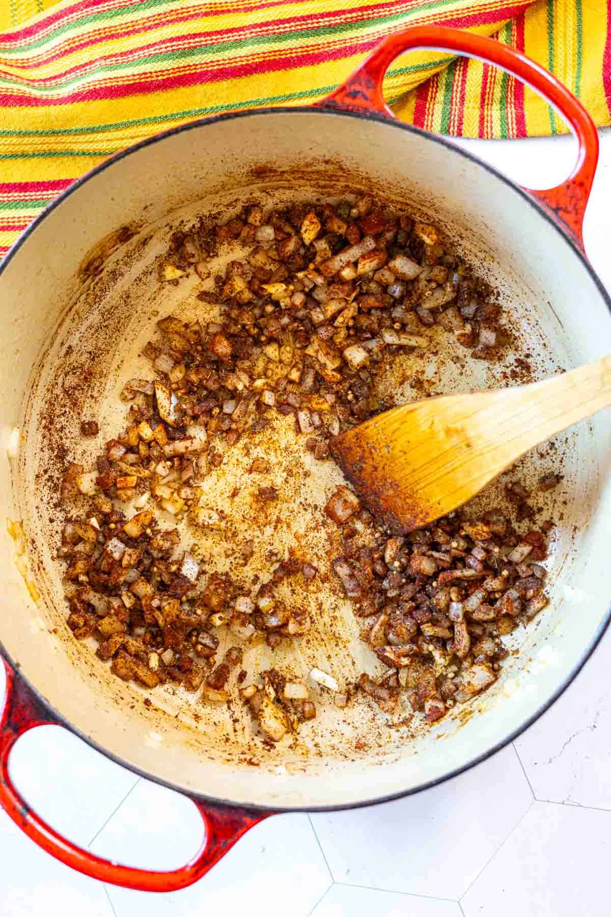 Cooking onions and spices to make Hatch Green Chili Colorado.