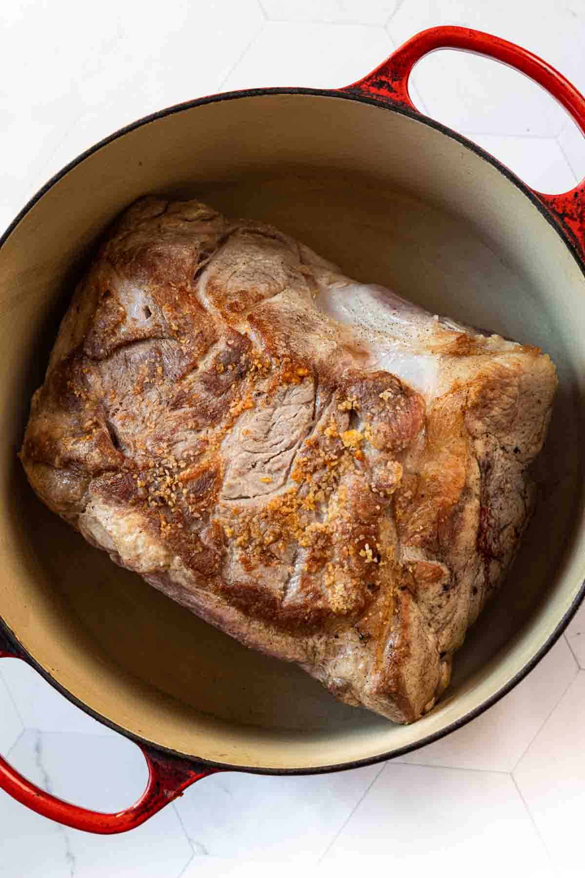 Seared pork roast in a Dutch oven to make Hatch Green Chili with Pork.