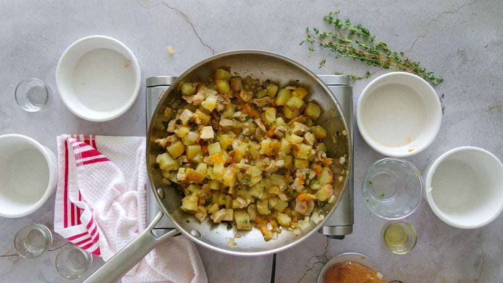 Cooking chicken potato hash in a skillet