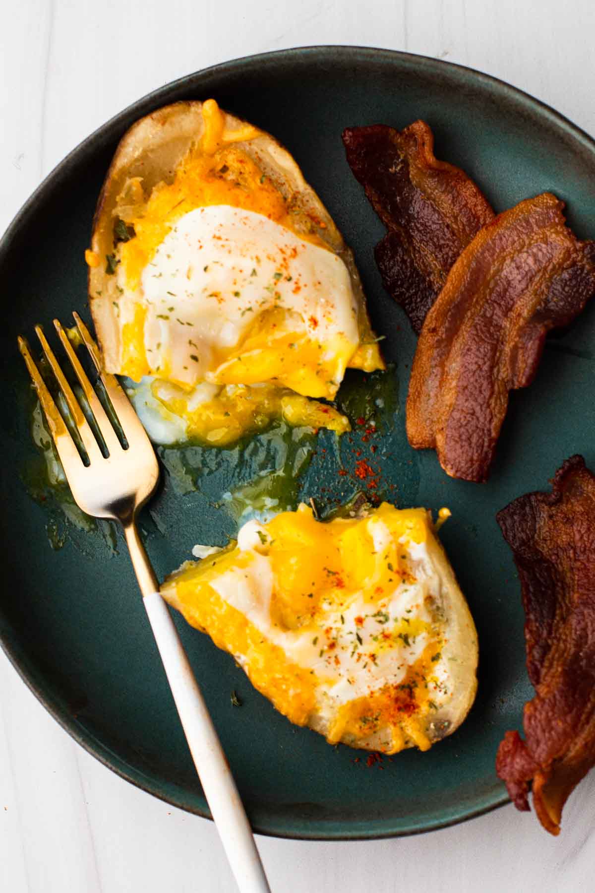 Twice baked breakfast potato served with bacon.
