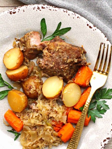 country style pork ribs cooked in slow cooker served with potatoes, carrots and sauerkraut