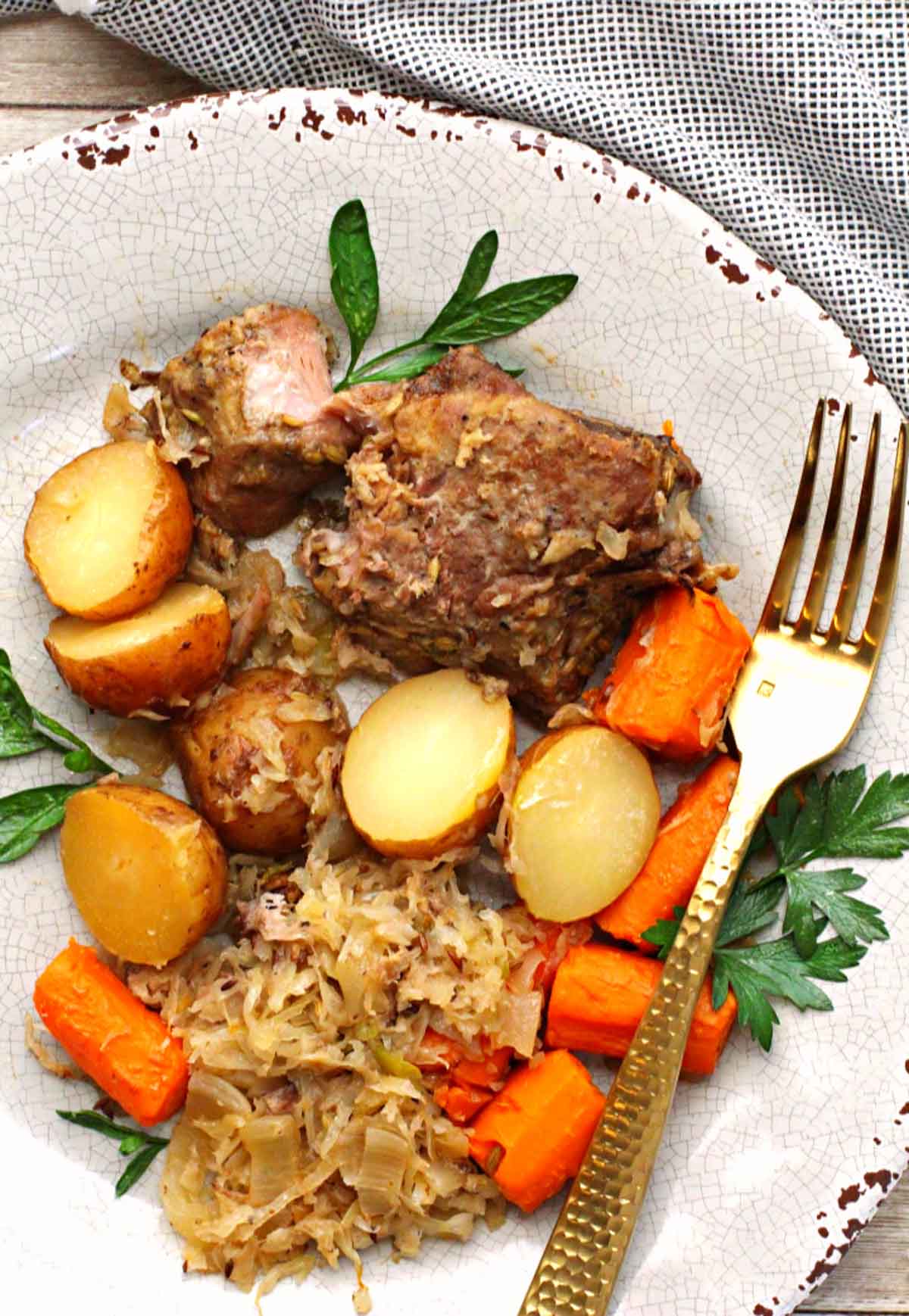 country style pork ribs cooked in slow cooker served with potatoes, carrots and sauerkraut
