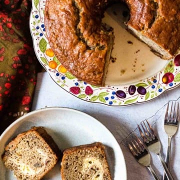 Banana coffee cake on a plate with three slices on another plate.