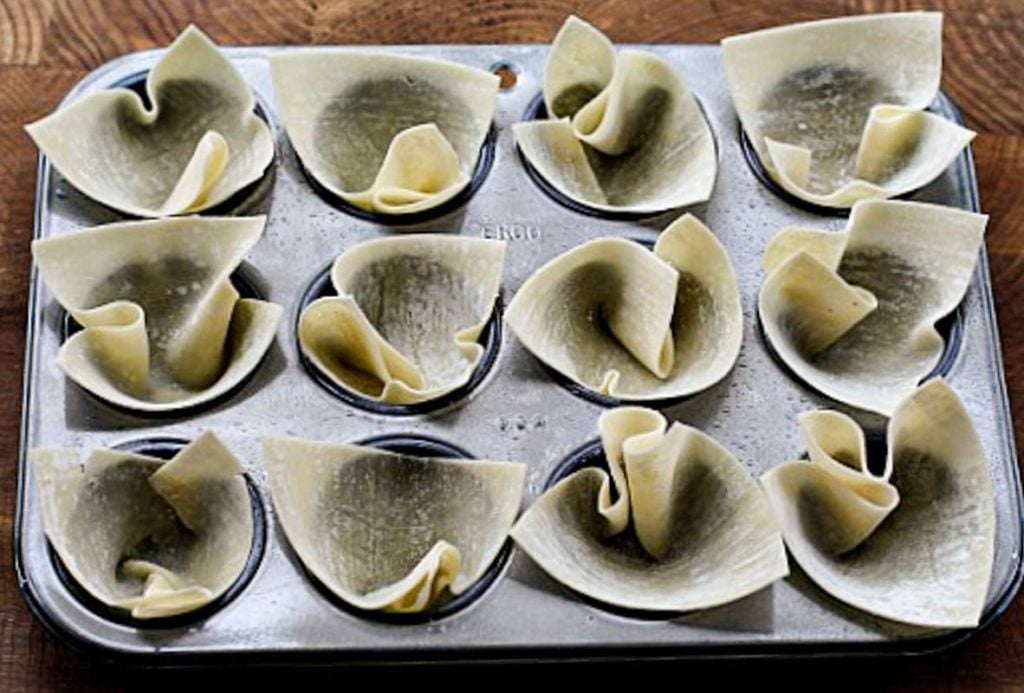 egg roll wrappers pressed into a mini muffin pan to make appetizers